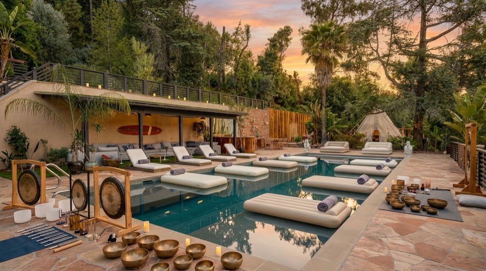 Pool deck arranged with gongs and loungers at sunset